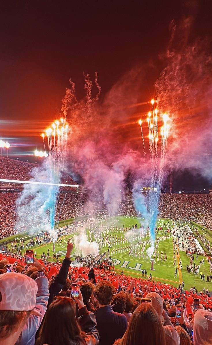 Fireworks and the marching band on the field at a packed Jordan-Hare Stadium at night